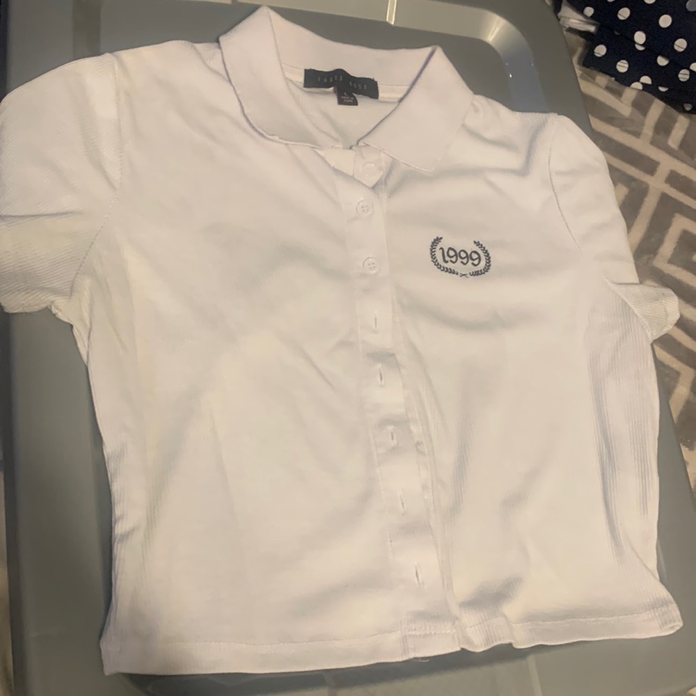 cropped polo shirt with “1999” on it.